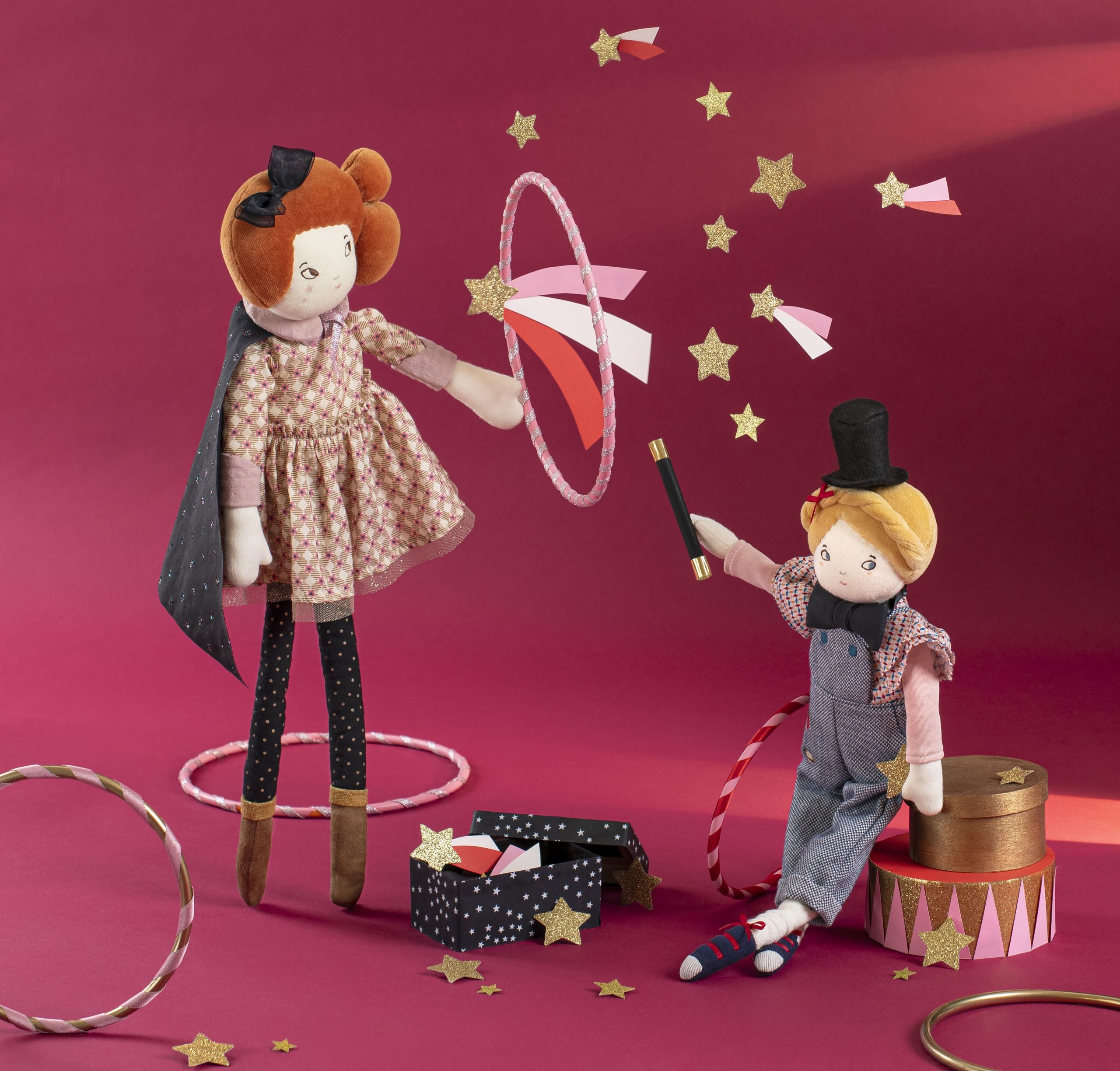 doll with red hair and doll with blonde hair, making magic tricks through the hoops