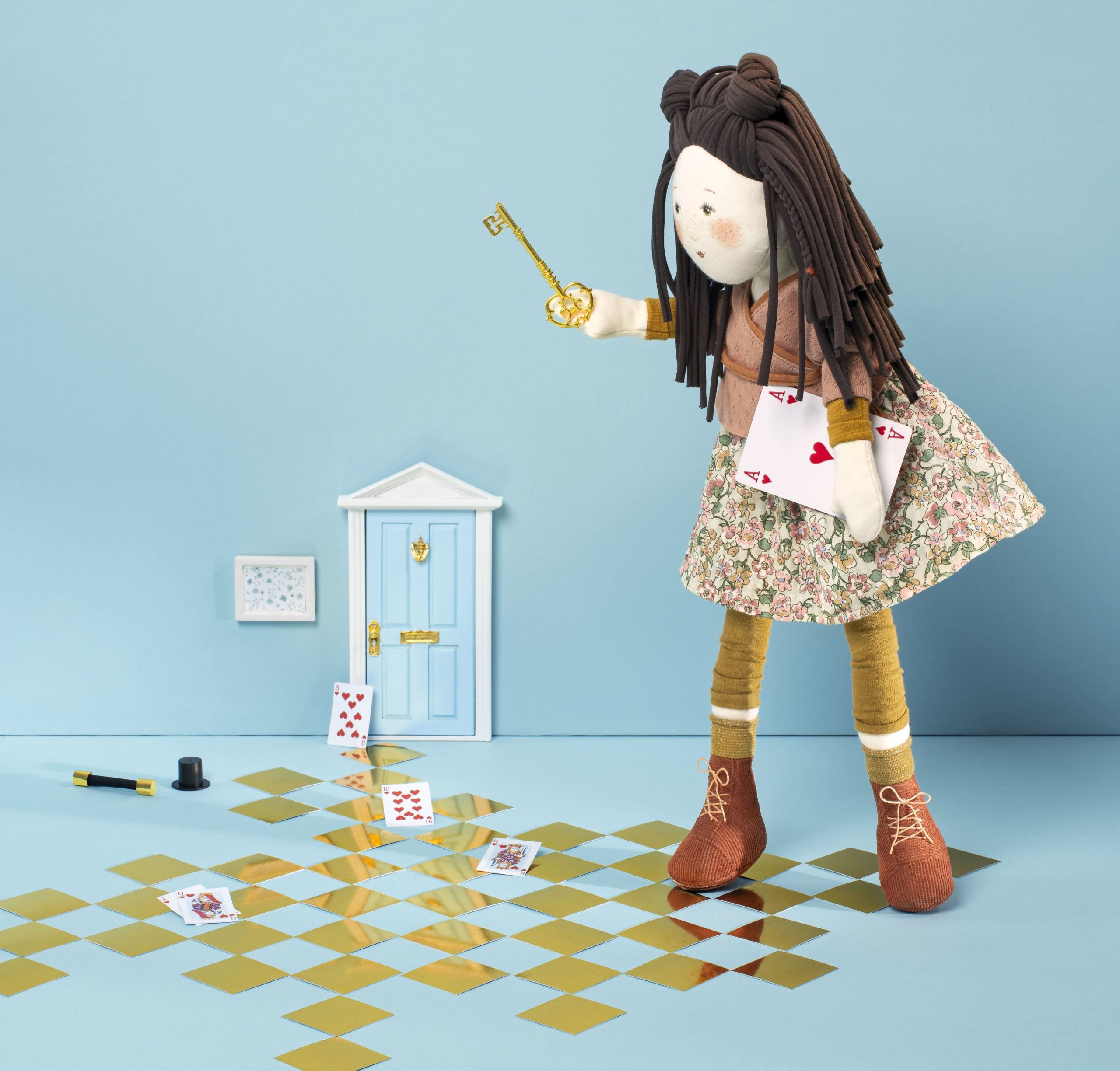 marjolane the doll making magic trick above a checkers board