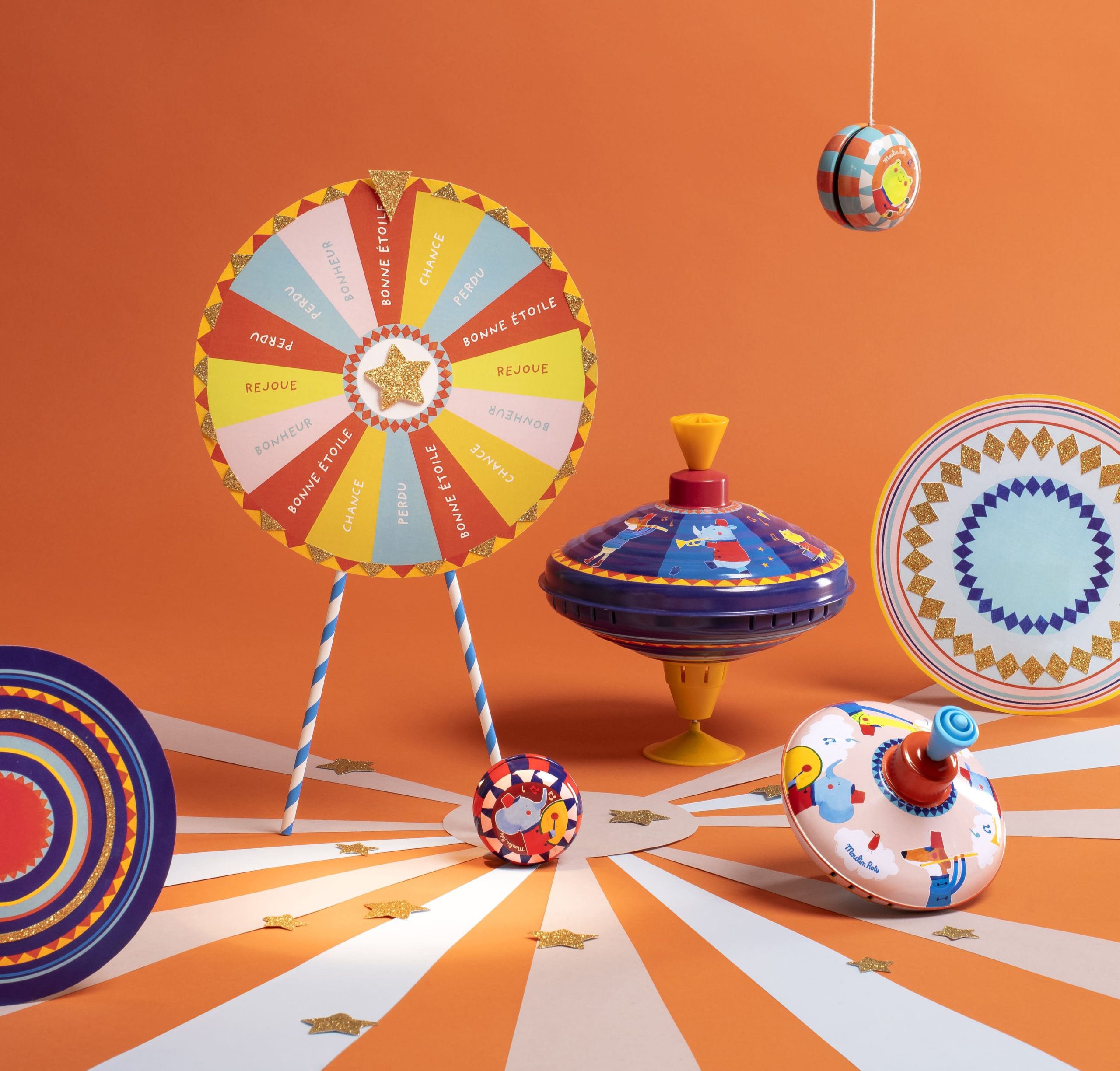 spinning tops and spinning wheels and yoyo's in an orange setting